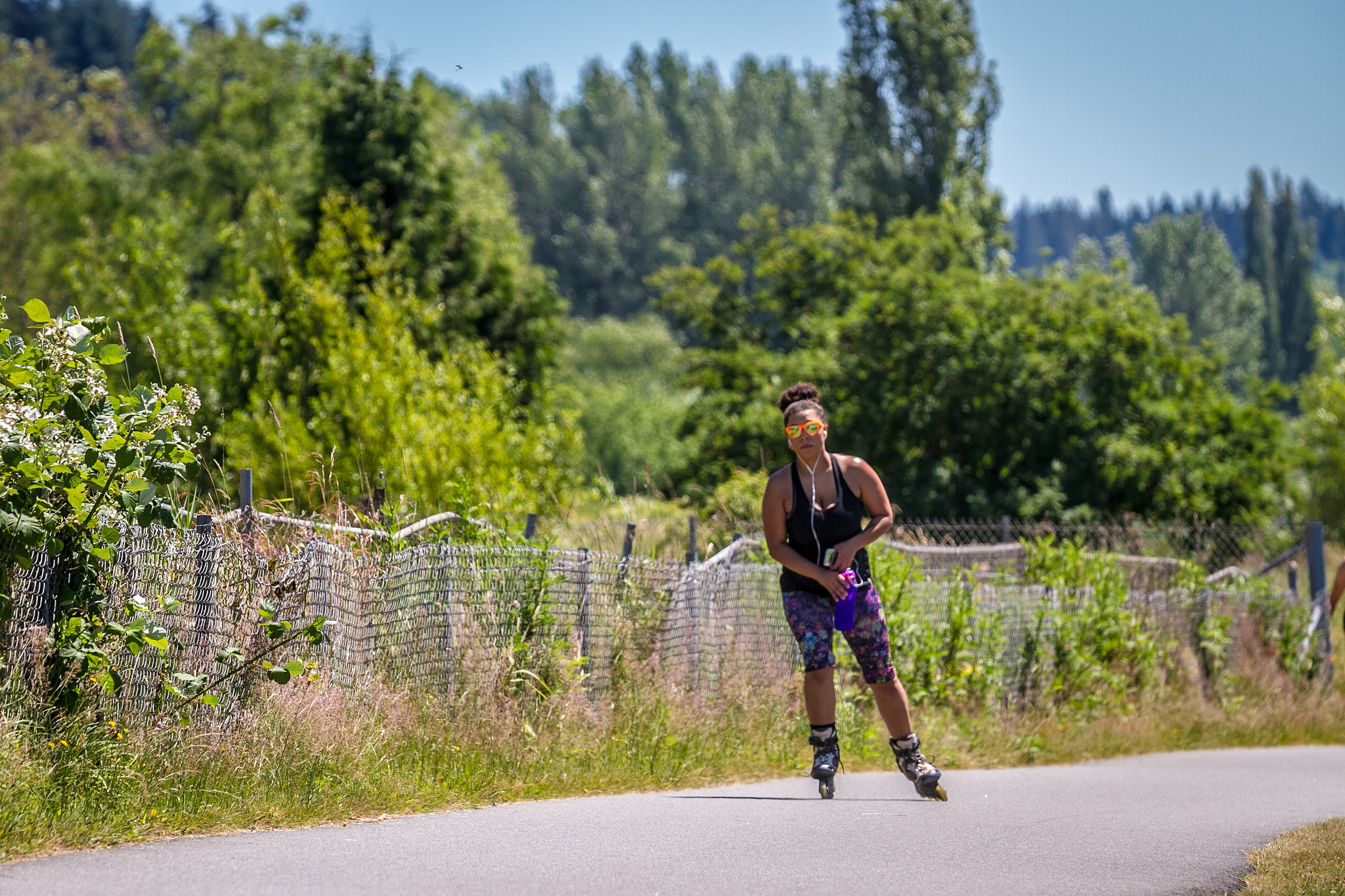 Woman rollerblading on a trail