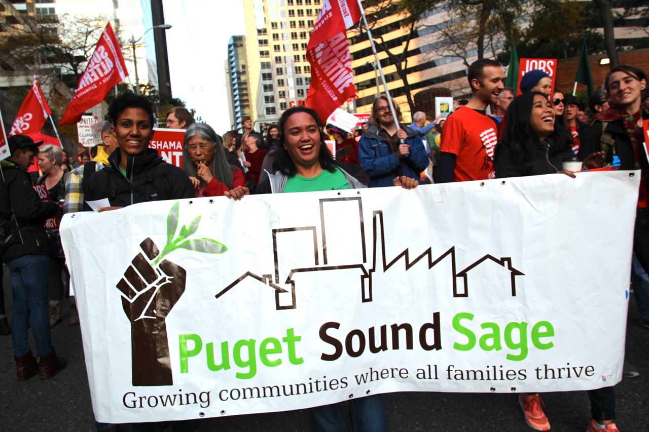 People marching with a PGS banner