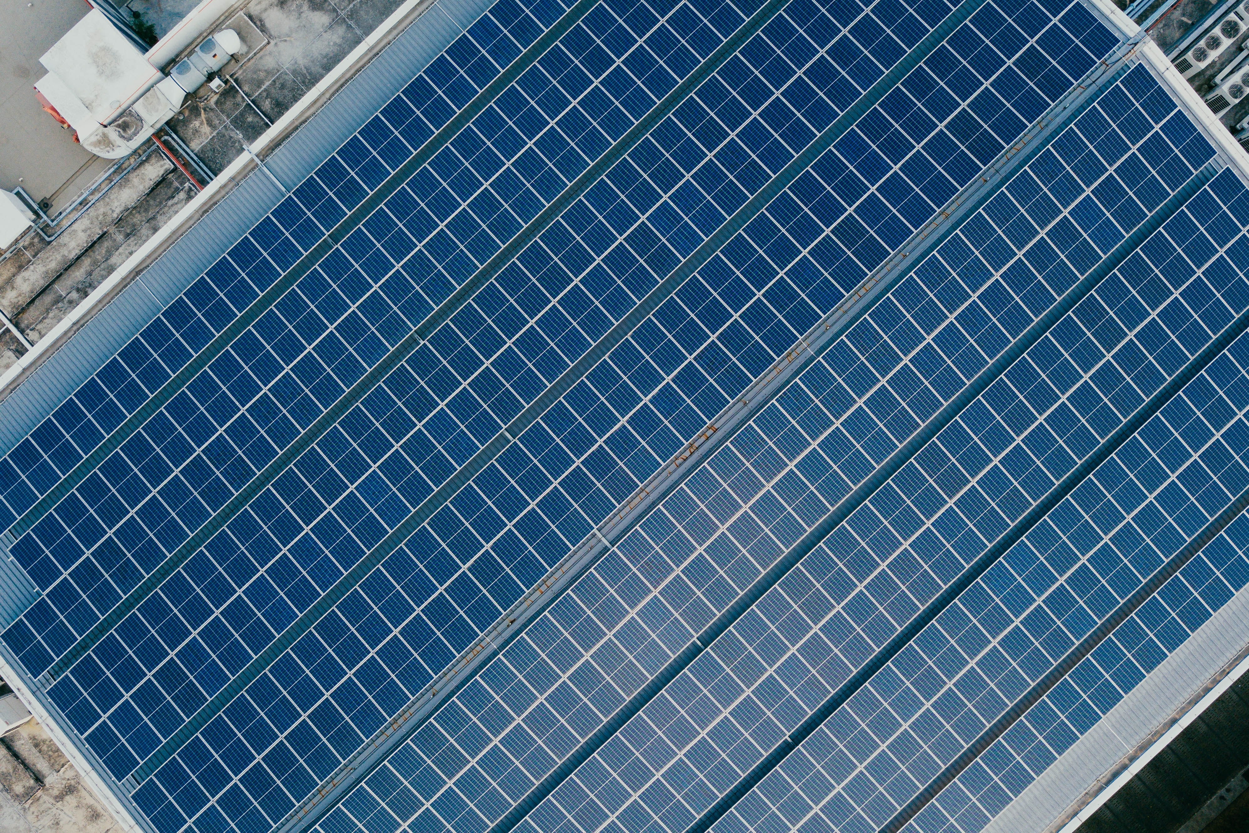 blue solar panels on a building roof