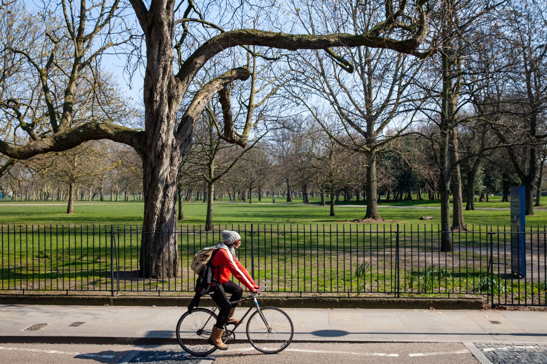 Person biking next to a park
